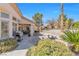 Manicured backyard featuring lush desert landscaping and an outdoor seating area at 10920 Black Ledge Ave, Las Vegas, NV 89134