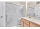 Bathroom featuring a glass shower, sink with wooden cabinet, and a mirror at 10920 Black Ledge Ave, Las Vegas, NV 89134