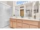 Bright bathroom featuring a double sink vanity and glass enclosed shower at 10920 Black Ledge Ave, Las Vegas, NV 89134