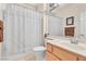 Bathroom featuring a white shower curtain and sink with wooden cabinet at 10920 Black Ledge Ave, Las Vegas, NV 89134