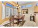 Cozy dining area with natural light, chandelier, and views to the outside at 10920 Black Ledge Ave, Las Vegas, NV 89134