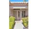 Close up of the front entrance showcasing a security screen door and pristine landscaping at 10920 Black Ledge Ave, Las Vegas, NV 89134