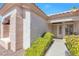Inviting front entrance with well-maintained bushes, decorative pillars, and a security screen door at 10920 Black Ledge Ave, Las Vegas, NV 89134