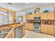 Well-equipped kitchen with stainless steel appliances, light cabinetry, and views to the dining area at 10920 Black Ledge Ave, Las Vegas, NV 89134