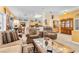 Spacious living room features neutral carpeting, comfortable furnishings, and views to the kitchen at 10920 Black Ledge Ave, Las Vegas, NV 89134