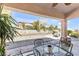 Covered patio area with outdoor seating and views of the landscaped backyard at 10920 Black Ledge Ave, Las Vegas, NV 89134