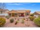 Landscaped backyard with desert plants, a patio area with furniture, and a view of the desert landscape at 10921 Grand Haven Ave, Las Vegas, NV 89134