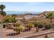 Beautiful Las Vegas city view overlooking desert landscaping with desert plants, palm trees, and wrought iron fencing at 10921 Grand Haven Ave, Las Vegas, NV 89134