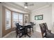 Cozy dining area with a bay window, shutter blinds, and comfortable seating for four at 10921 Grand Haven Ave, Las Vegas, NV 89134