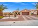 Single-story home featuring desert landscaping and a two-car garage at 10921 Grand Haven Ave, Las Vegas, NV 89134