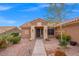 Charming front entrance with rock landscaping, sidewalk and an inviting covered entry with lights and tiled roof at 10921 Grand Haven Ave, Las Vegas, NV 89134