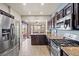 Beautiful kitchen with stainless steel appliances and granite countertops with backyard access at 10921 Grand Haven Ave, Las Vegas, NV 89134
