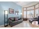 Comfortable living room with a bay window, tile flooring, a leather sofa, and modern lighting at 10921 Grand Haven Ave, Las Vegas, NV 89134