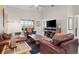 Comfortable living room with plush seating, a large window, and neutral wall colors at 10921 Grand Haven Ave, Las Vegas, NV 89134