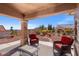 Inviting covered patio with desert landscaping, providing an ideal outdoor living space and beautiful views at 10921 Grand Haven Ave, Las Vegas, NV 89134