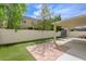 A backyard features artificial grass, a covered patio, a white fence, and a shed at 1131 Sax Fifth Ave, Henderson, NV 89052