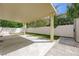 Backyard featuring artificial grass, a covered patio, and a white block wall at 1131 Sax Fifth Ave, Henderson, NV 89052