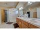 Elegant bathroom featuring double sinks, framed mirror and shower at 1131 Sax Fifth Ave, Henderson, NV 89052