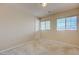 Bedroom with carpet, two windows, and white walls at 1131 Sax Fifth Ave, Henderson, NV 89052