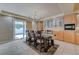 Bright dining room featuring a wooden table with six chairs and sliding glass doors leading to the outside at 1131 Sax Fifth Ave, Henderson, NV 89052