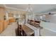 Open-concept design with a dining room featuring a rustic wooden table and a view of the kitchen and living area at 1131 Sax Fifth Ave, Henderson, NV 89052