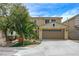 Inviting two-story home featuring a well-maintained lawn, desert landscaping, and attached two-car garage at 1131 Sax Fifth Ave, Henderson, NV 89052