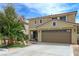 Inviting two-story home featuring a well-maintained lawn, desert landscaping, and attached two-car garage at 1131 Sax Fifth Ave, Henderson, NV 89052