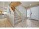 Inviting foyer with tile flooring, staircase, and convenient access to the front entrance and kitchen at 1131 Sax Fifth Ave, Henderson, NV 89052