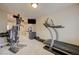 Well-equipped home gym featuring a treadmill and weight machines for a complete workout experience at 1131 Sax Fifth Ave, Henderson, NV 89052