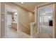Upstairs hallway leading to a bathroom with dual sinks and a bedroom, showcasing a well-lit and accessible layout at 1131 Sax Fifth Ave, Henderson, NV 89052