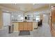 Modern kitchen with island and breakfast bar, stainless steel appliances, granite countertops, tile flooring at 1131 Sax Fifth Ave, Henderson, NV 89052