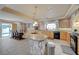 Spacious eat-in kitchen with island and dining table, granite countertops, stainless steel appliances, and tile flooring at 1131 Sax Fifth Ave, Henderson, NV 89052