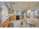 Bright kitchen featuring granite counters, wooden cabinetry, tile backsplash and floors, and modern appliances at 1131 Sax Fifth Ave, Henderson, NV 89052