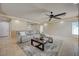 Bright living room featuring tile flooring, modern ceiling fan, and comfortable seating arrangement at 1131 Sax Fifth Ave, Henderson, NV 89052