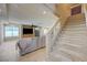 Spacious living room with tile flooring, cozy seating, and staircase access to the upper level at 1131 Sax Fifth Ave, Henderson, NV 89052