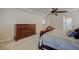 Relaxing main bedroom featuring an elegant headboard, ceiling fan and natural light at 1131 Sax Fifth Ave, Henderson, NV 89052