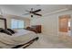 Relaxing main bedroom featuring an elegant headboard, ceiling fan and natural light at 1131 Sax Fifth Ave, Henderson, NV 89052
