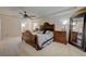 Relaxing main bedroom featuring an elegant headboard, ceiling fan and natural light at 1131 Sax Fifth Ave, Henderson, NV 89052