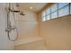 Shower stall featuring a shower head, seat, and glass block window at 1131 Sax Fifth Ave, Henderson, NV 89052