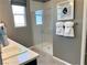 Modern bathroom featuring a tiled floor, window and shower with seamless glass door at 116 Antler Square Ln, Henderson, NV 89011