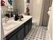 Bathroom with dual sinks, patterned floors, and modern fixtures at 116 Antler Square Ln, Henderson, NV 89011