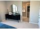Relaxing bedroom featuring a black dresser with round mirror and ensuite bathroom entrance at 116 Antler Square Ln, Henderson, NV 89011
