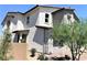 Angle view of a two-story stucco home with a two-car garage, brick driveway, and a well manicured yard at 116 Antler Square Ln, Henderson, NV 89011