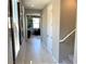 Inviting hallway with light wood floors leading to a cozy living area; adjacent staircase to upper level at 116 Antler Square Ln, Henderson, NV 89011