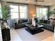 Bright living room with neutral colors, large windows, stylish furniture, and easy access to the backyard at 116 Antler Square Ln, Henderson, NV 89011