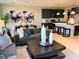 Open-concept living and dining area with stylish decor, seamlessly connected to a modern kitchen with bar seating at 116 Antler Square Ln, Henderson, NV 89011