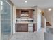 Modern bar area with a sink, mini-fridge, and cabinetry for storing drinks and barware at 12249 Catanzaro Ave, Las Vegas, NV 89138