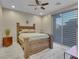 Stylish bedroom showcasing a wooden bed frame and modern window blinds at 12249 Catanzaro Ave, Las Vegas, NV 89138