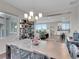 Bright dining room with view of the open-concept living space, kitchen, and backyard through large windows at 12249 Catanzaro Ave, Las Vegas, NV 89138