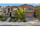 Stunning two-story home with lush landscaping and a charming brick driveway at 12249 Catanzaro Ave, Las Vegas, NV 89138